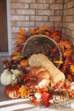 02-easy-pumpkins-and-hay-arrangement-in-a-bucket-on-a-porch.jpg